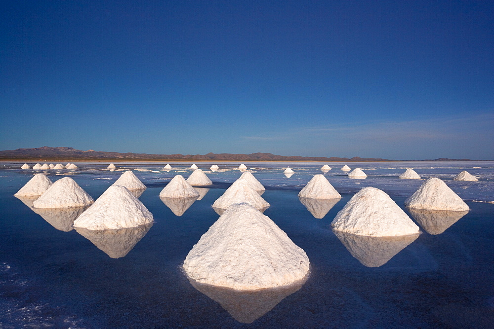 Piles of salt dry in the arid atmosphere of Bolivia's Salar de Uyuni, Salar de Uyuni, Bolivia