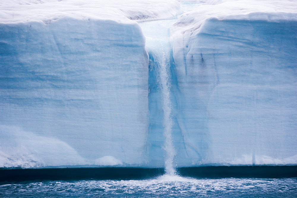 A waterfall is created by a melting iceberg, Svalbard, Norway, Svalbard, Norway