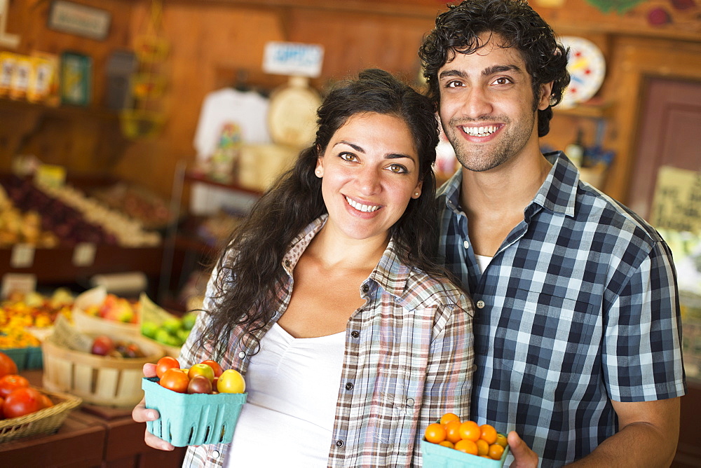 A farm growing and selling organic vegetables and fruit. A man and woman working together, Hurley, New York, USA