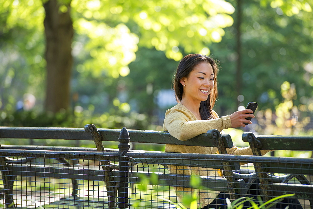 A small group of people, a businesswoman and two businessmen outdoors in the city.