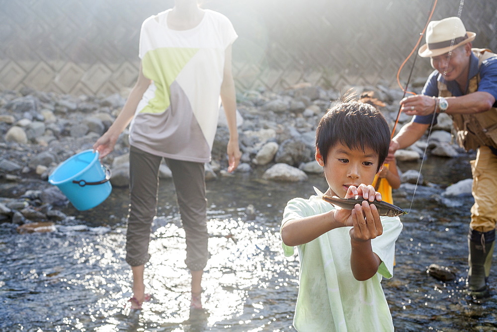 Family fishing in a stream, Kyoto, Honshu Island, Japan