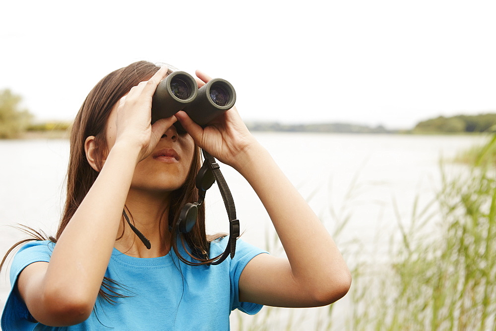 A young girl, a birdwatcher with binoculars, Bristol, Avon, England