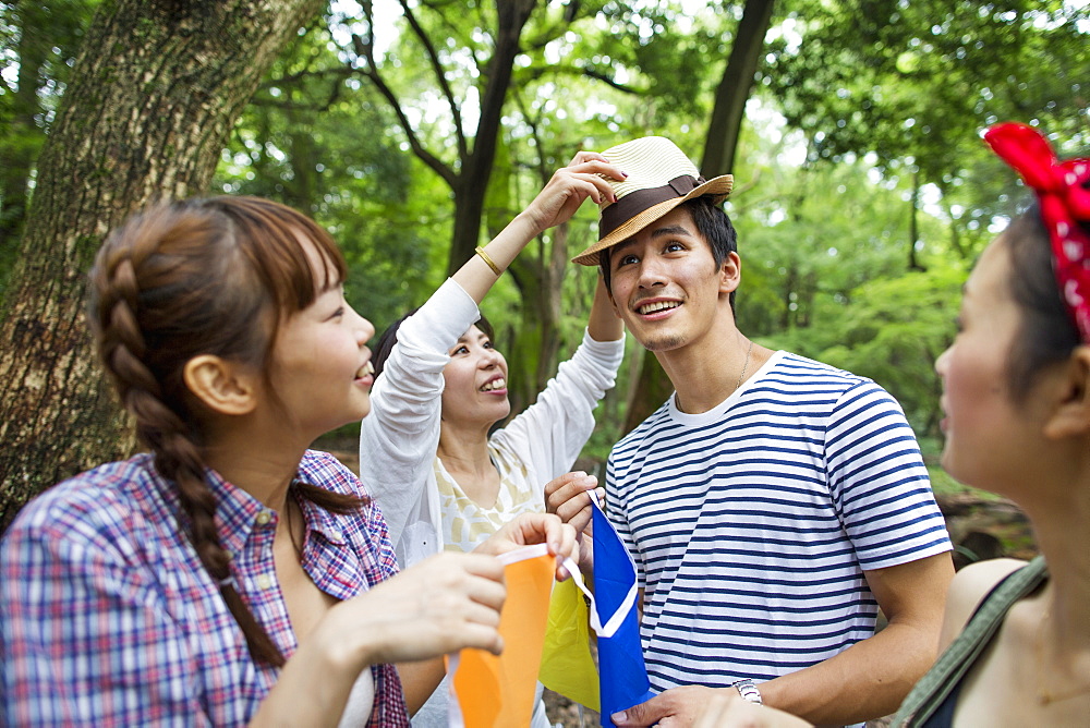 Group of friends at an outdoor party in a forest, Kyoto, Japan