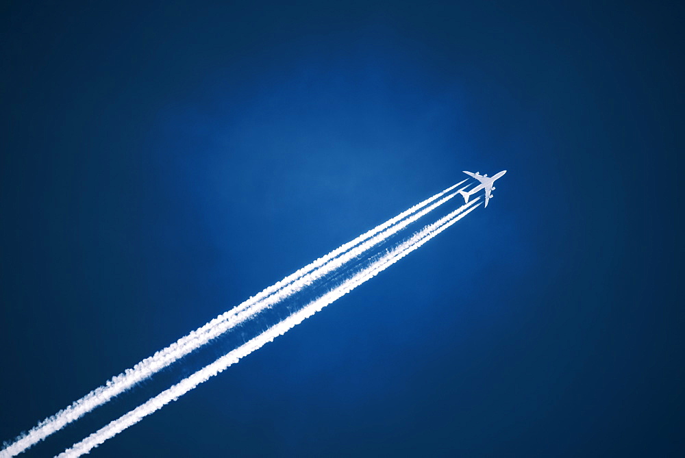 A jet vapour trail across a dark blue sky, Jet contrail, Saskatchewan, Canada