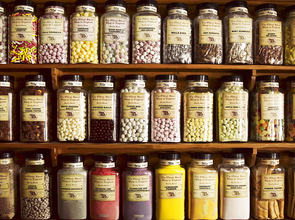 Traditional sweets displayed in tall glass jars on the shelves of a sweet shop, Sweet Shop, Yorkshire, England