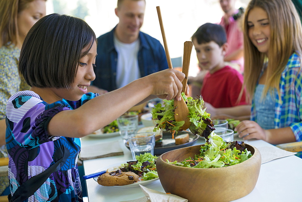 A family party around a table in a cafe. Adults and children, Woodstock, New York, USA