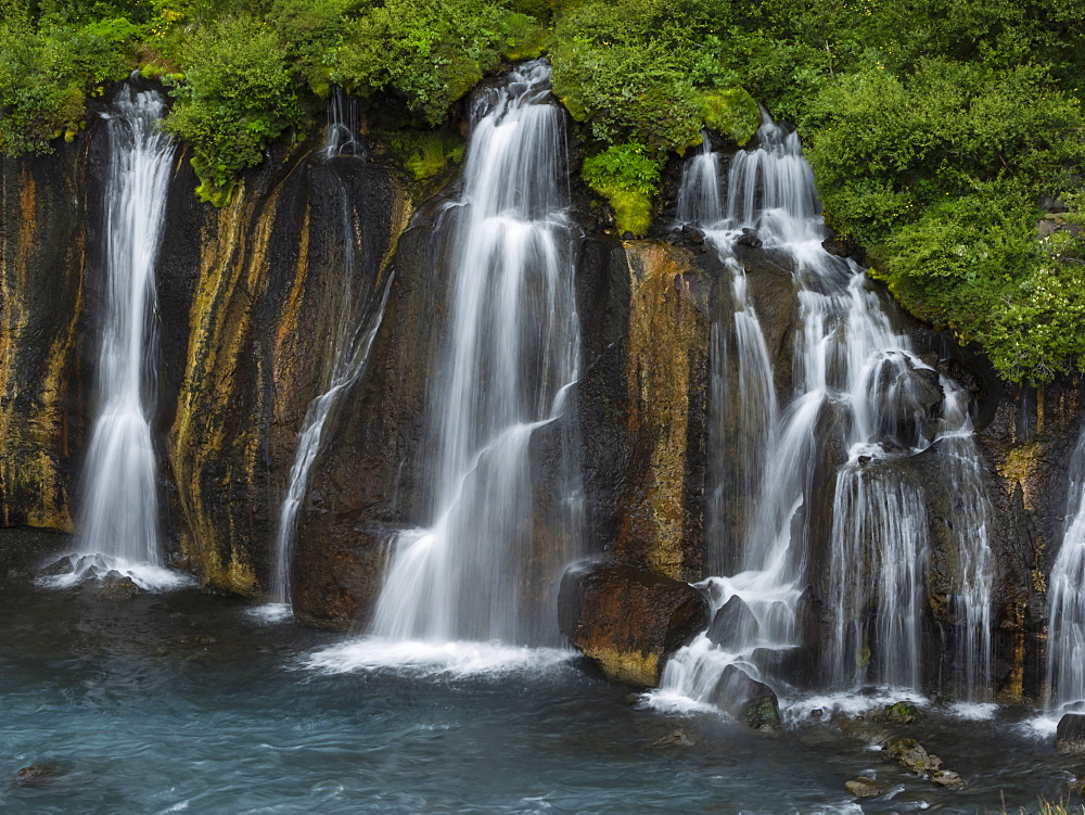 Hraunfossar waterfalls, a series of cascading torrents flowing from lava fields over a sheer cliff into the river Hvita, Iceland