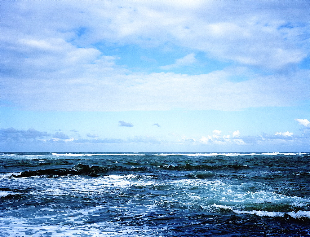 View across a wavy ocean under a cloudy sky, United States of America