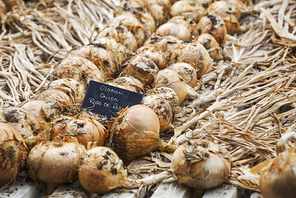 Onions on wooden tray.