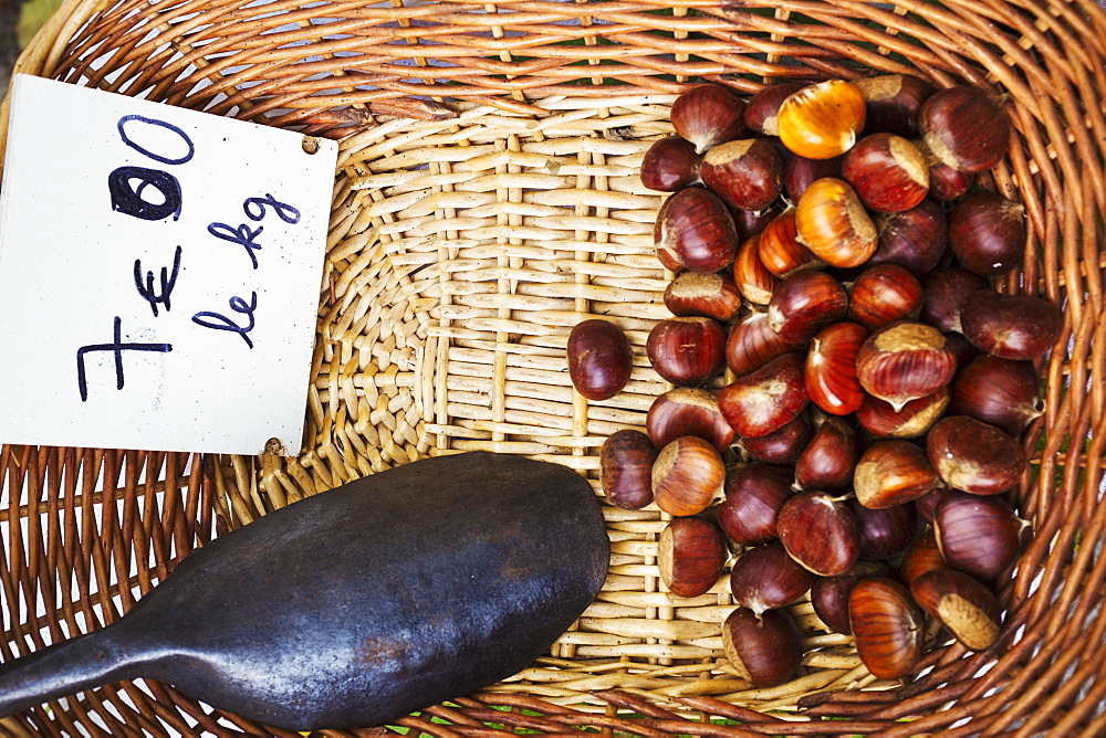 A basket of roasted sweet edible chestnuts, France