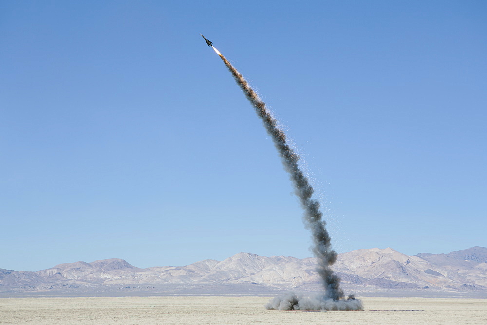 Rocket shooting into vast, desert sky, Black Rock Desert, Nevada, United States of America