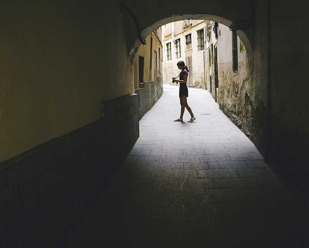 Teenage girl composing photo with digital camera, Gothic Quarter, Barcelona, Spain, Spain