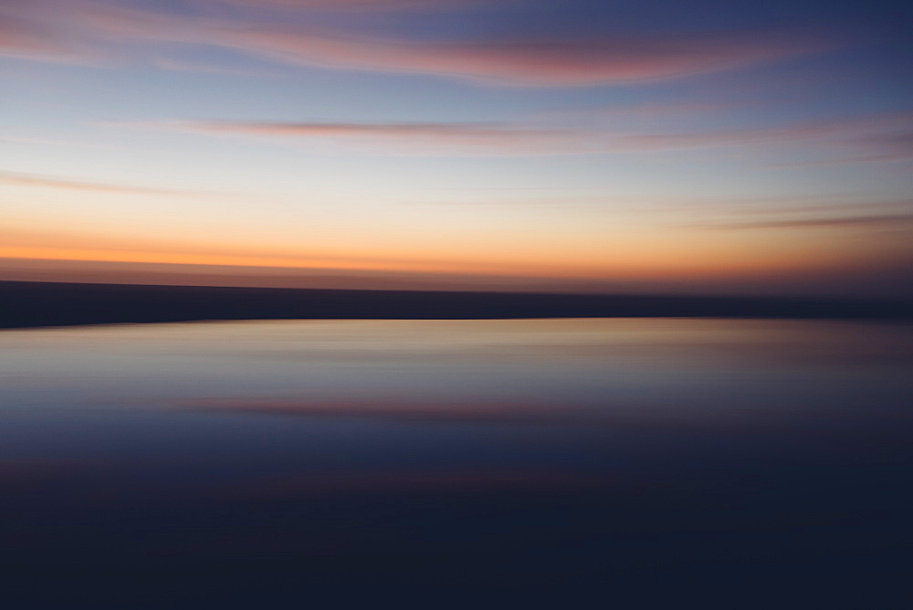 Seascape with cloudy sky at sunset.