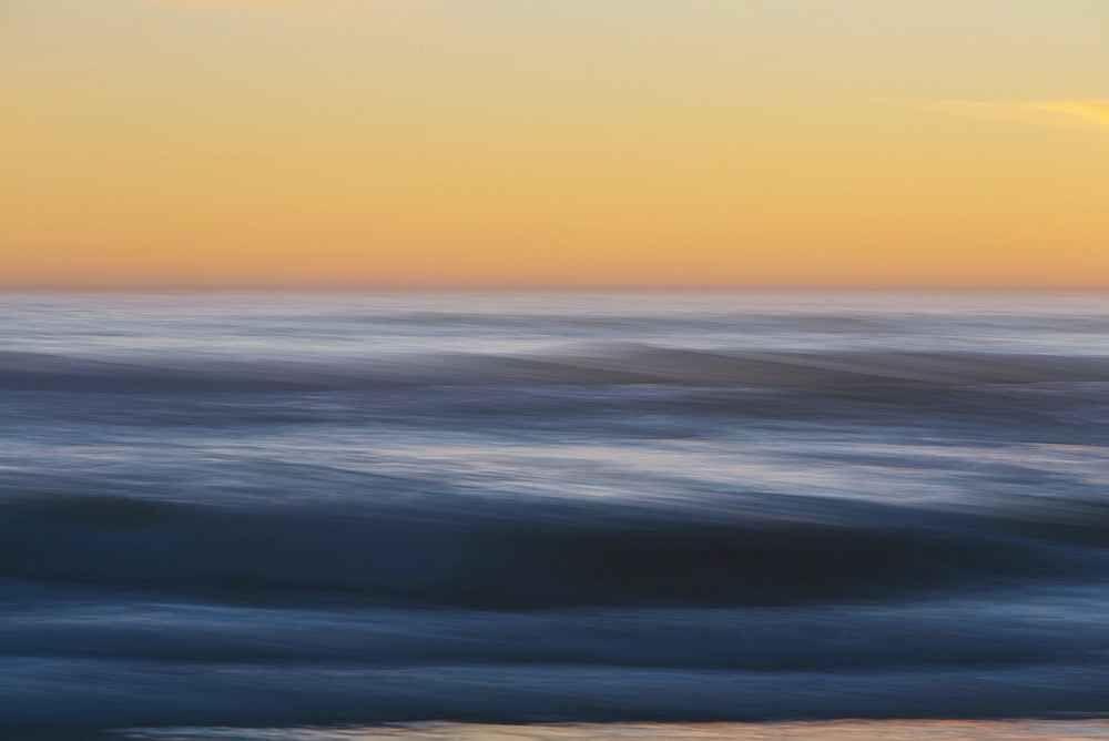 Seascape with cloudy sky at sunset.