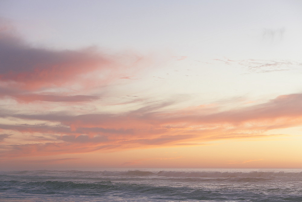 Seascape with cloudy sky at sunset.