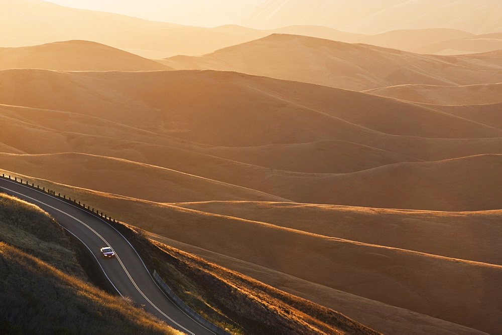 A view looking down of a car moving on a highway at sunrise near Lewiston, Idaho USA, United States of America