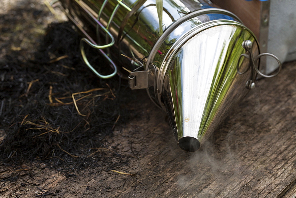 Close up of metal smoker used by beekeeper to calm bees, England, United Kingdom