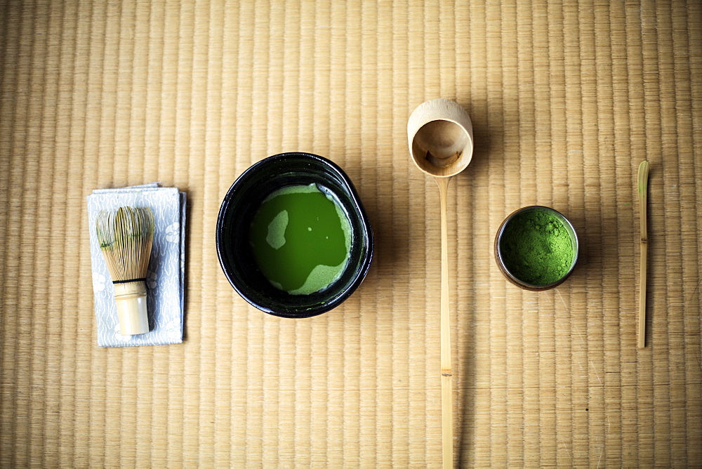 Tea ceremony utensils including bowl of green Matcha tea and bamboo whisk, Kyushu, Japan