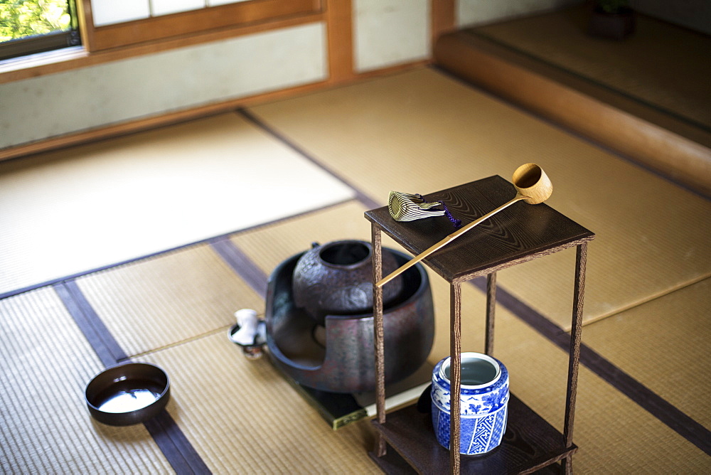 Traditional Japanese Tea Ceremony, high angle view of water container and small stand with a Hishaku, a bamboo ladle, on a tatami mat, Kyushu, Japan