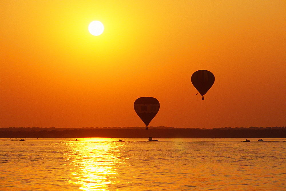 Hot Air Balloons Over Water at Sunset, Texas, United States of America