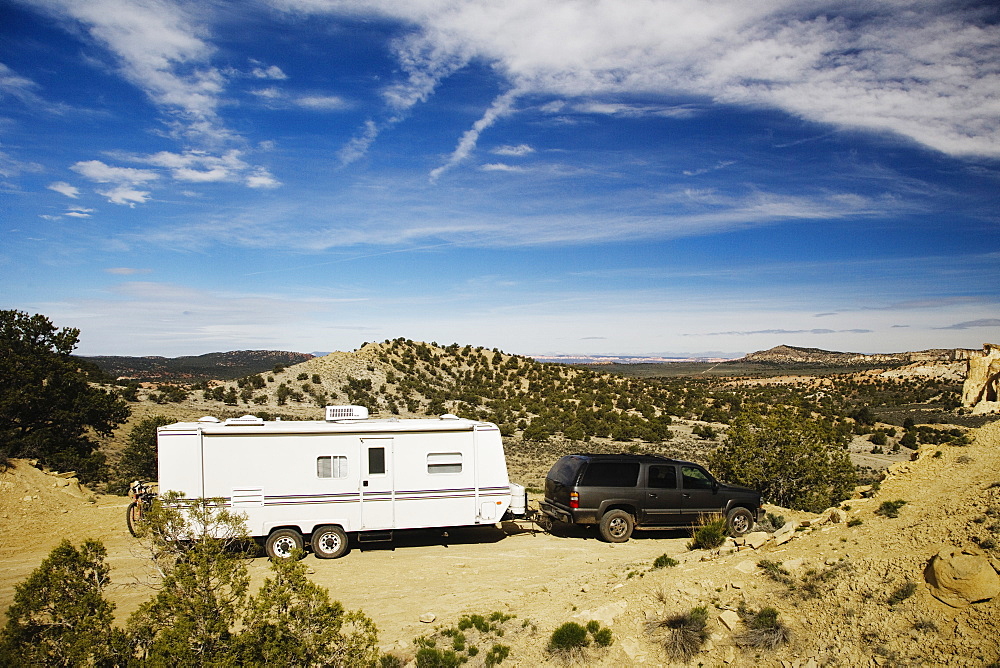 Car pulling trailer in desert landscape, Grand Staircase Escalante, Utah, United States, Grand Starcase Escalante, Utah, USA