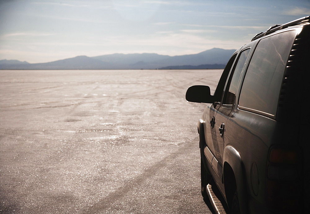 Close up of car driving on salt flats, Bonnaville Salt Flats, Utah, United States, Valley Of the Gods, Utah, USA