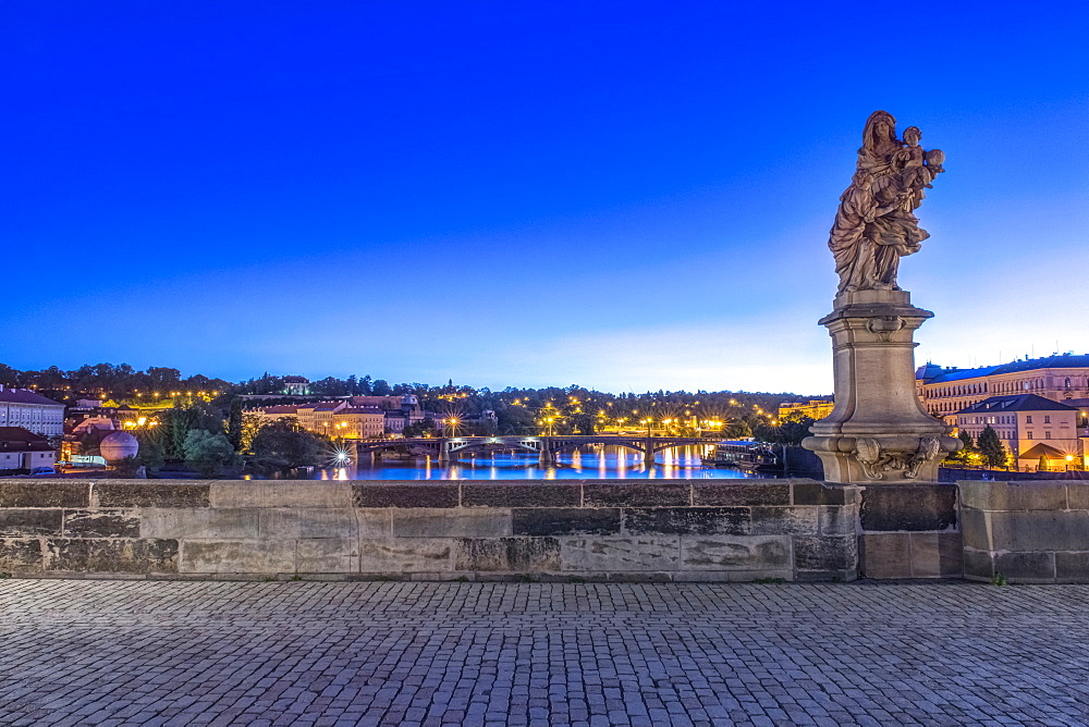 Statue and cobblestones on Charles Bridge at dawn, Prague, Czech Republic