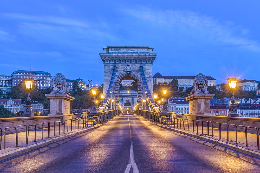 Lion statues and illuminated streetlamps along Chain Bridge, Budapest, Hungary