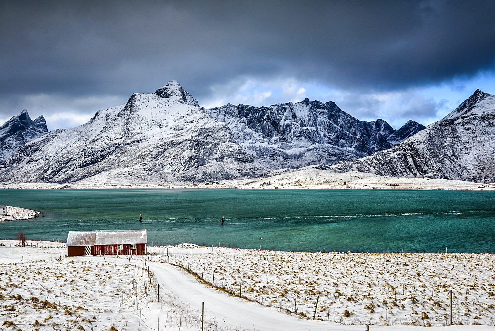 Snowy mountains overlooking ocean, Reine, Lofoten Islands, Norway