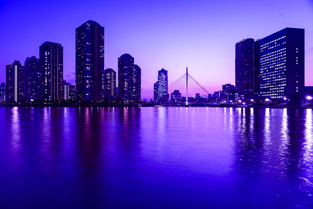 Silhouette of Tokyo skyline lit up at night, Koto, Tokyo, Japan