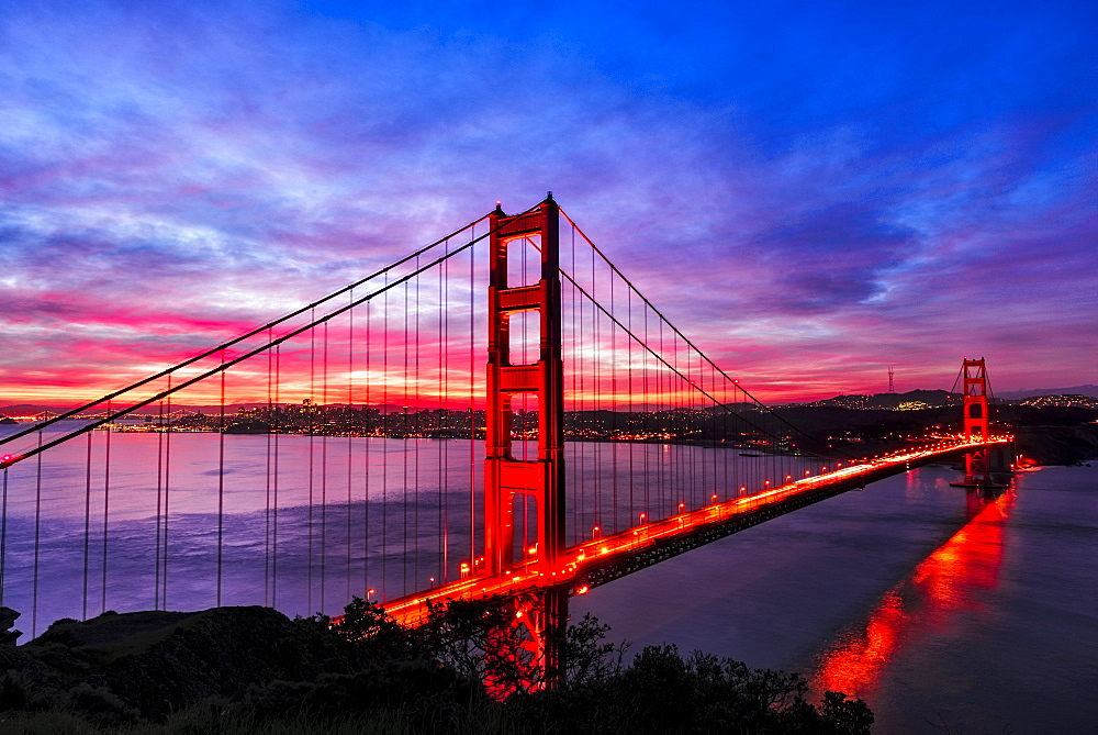 Golden Gate Bridge lit up at sunset, San Francisco, California, United States