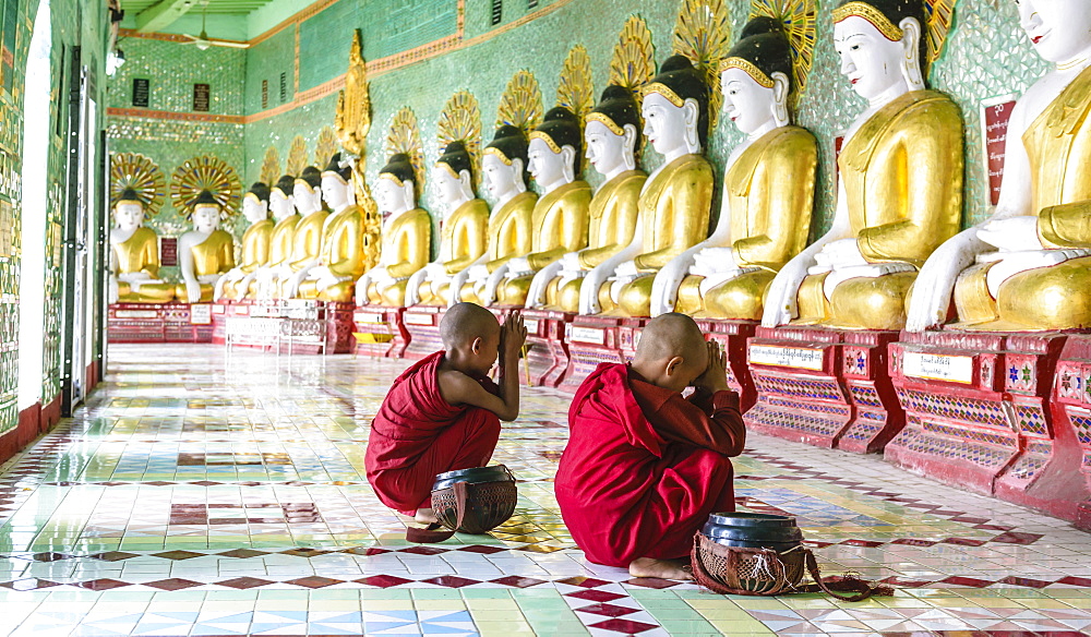 Asian Buddhist monks praying in temple, Mingun, Saigang, Myanmar