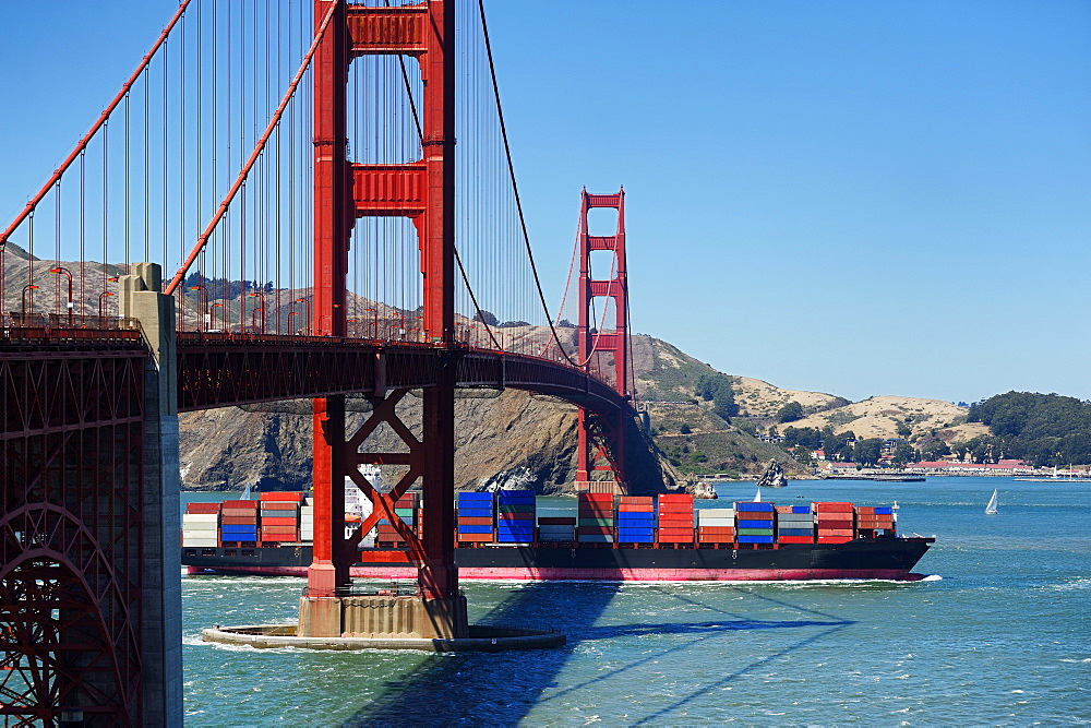 Barge passing under Golden Gate Bridge, San Francisco, California, United States