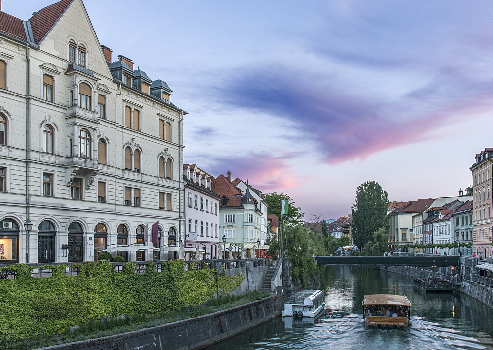 Buildings and pedestrian bridge over urban canal, Ljubljana, Central Slovenia, Slovenia