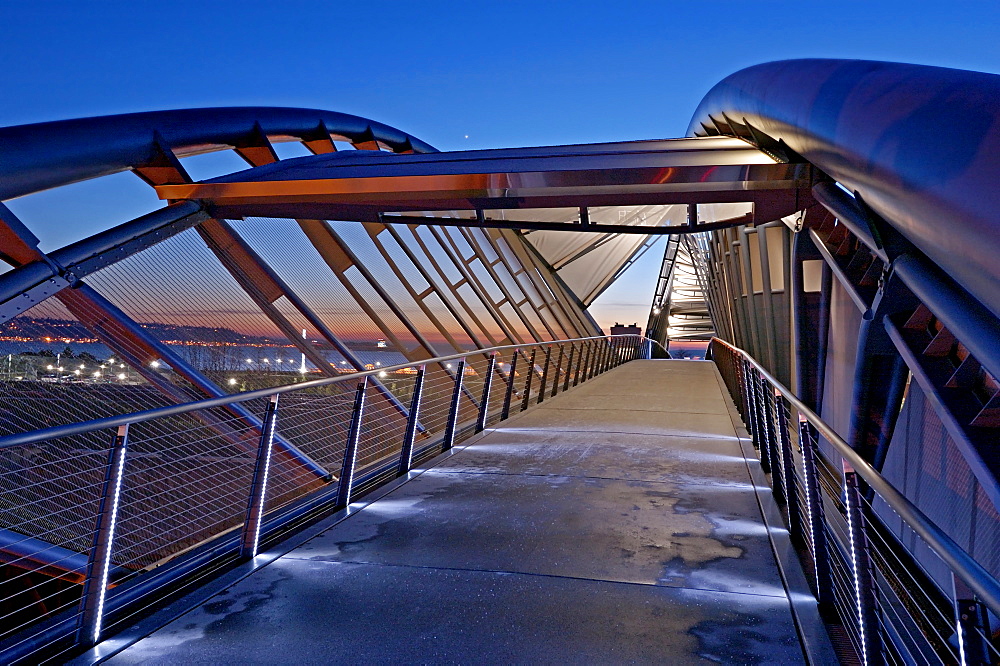 Illuminated footbridge over Seattle cityscape at night, Washington, United States