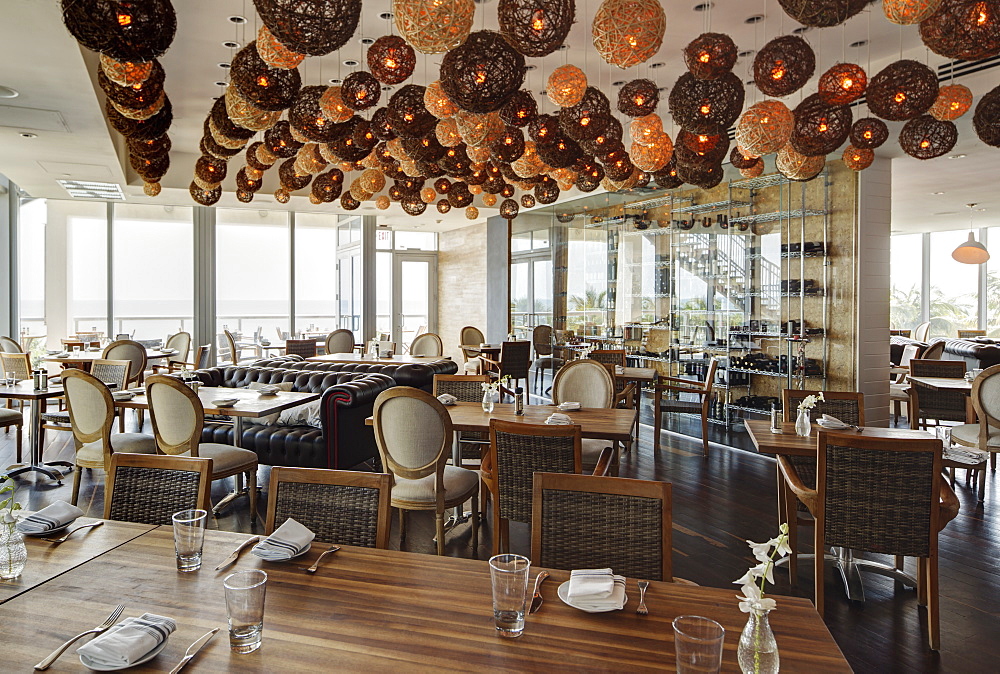 Lanterns over tables in modern restaurant, Miami, Florida, USA