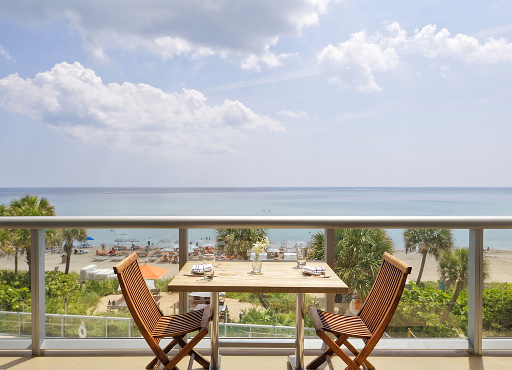 Empty table on restaurant balcony overlooking beach, Miami, Florida, USA