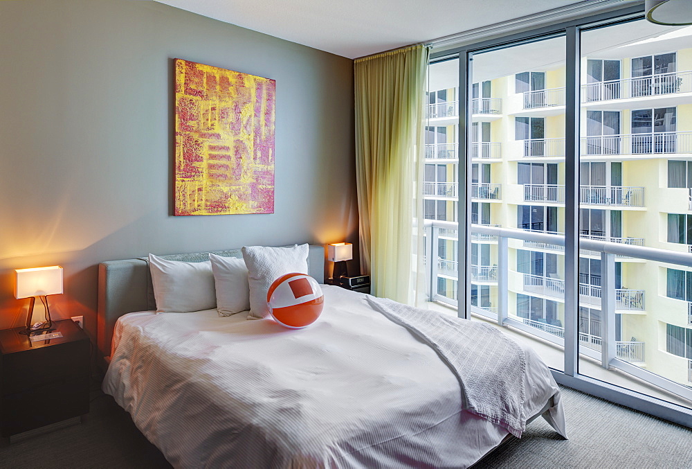 Beach ball on bed in hotel room, Miami, Florida, USA