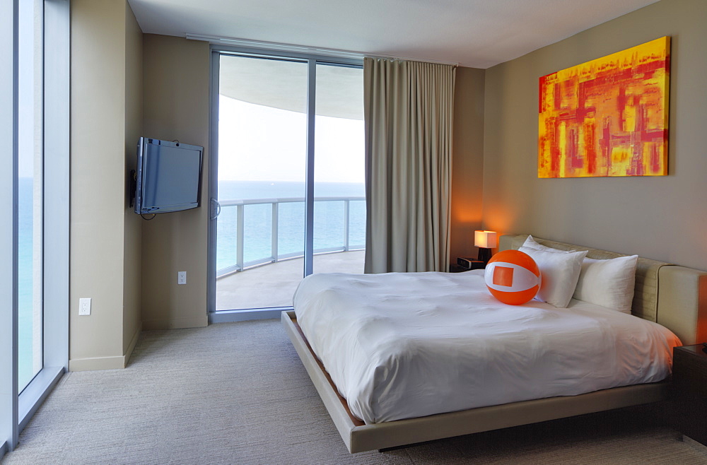 Beach ball on bed in hotel room, Miami, Florida, USA