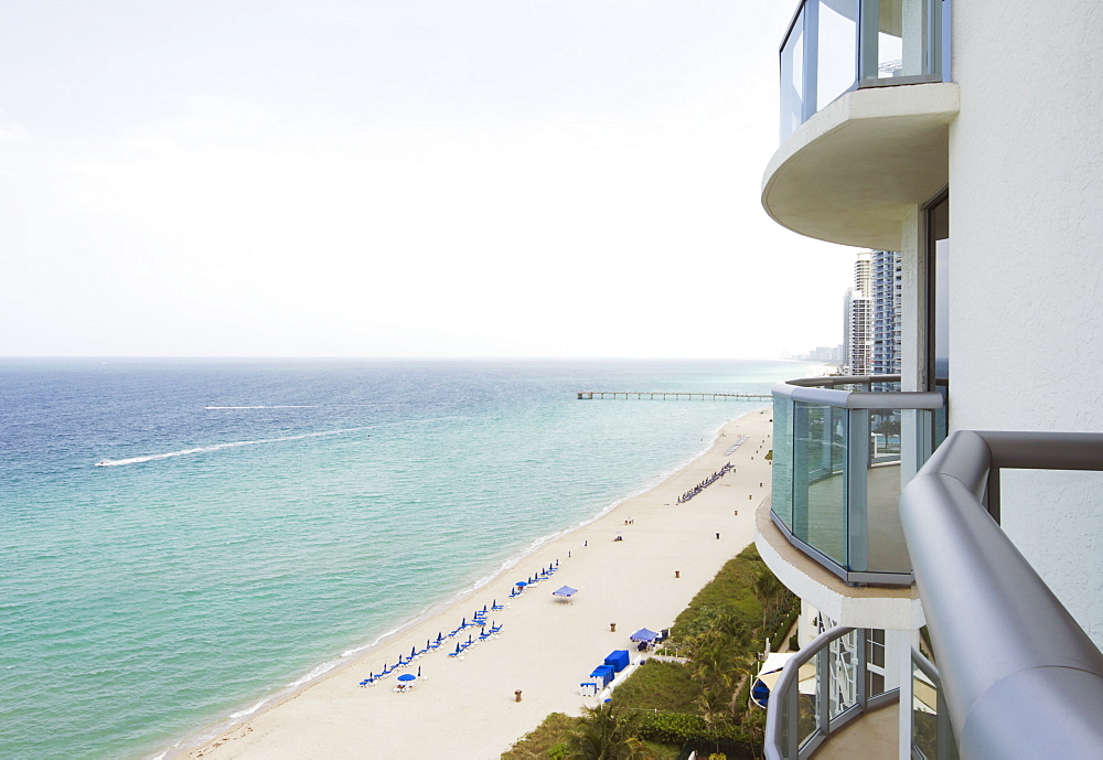 Hotel balcony overlooking urban beach, Miami, Florida, USA