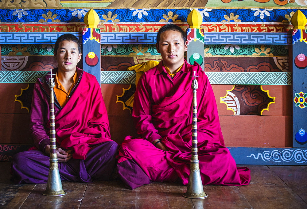 Asian monks sitting on temple floor, Bhutan, Kingdom of Bhutan