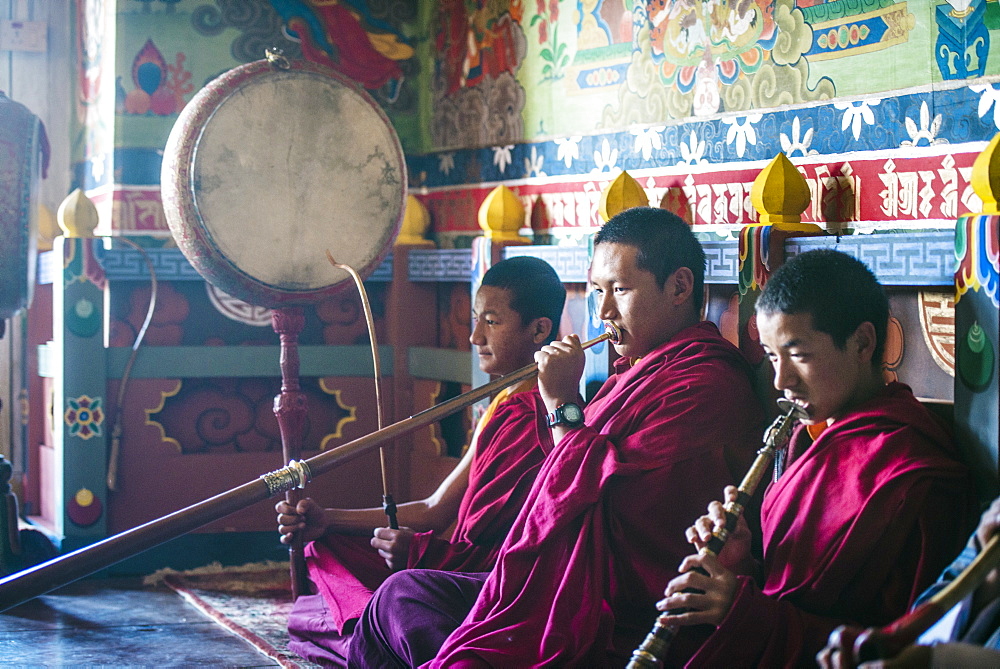 Asian monks playing instruments on temple floor, Bhutan, Kingdom of Bhutan