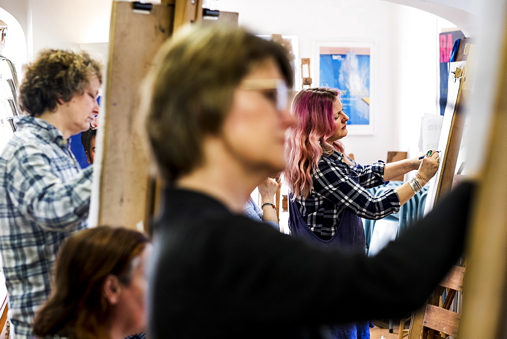 Close up of a woman standing at an easel, drawing, Oxfordshire, England