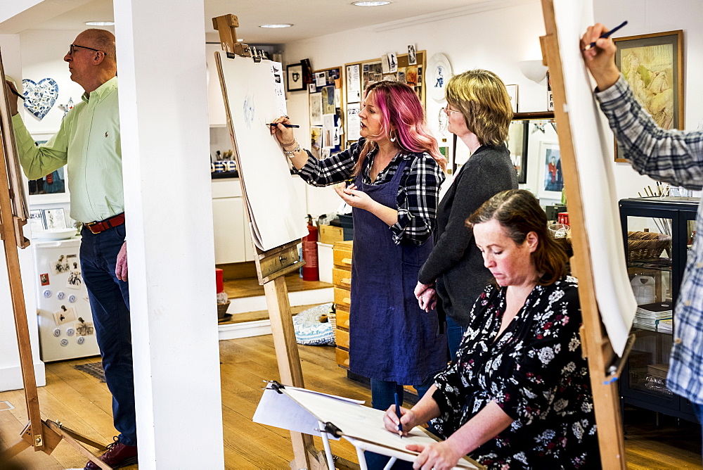 Group of artists standing and sitting at easels, drawing, Oxfordshire, England