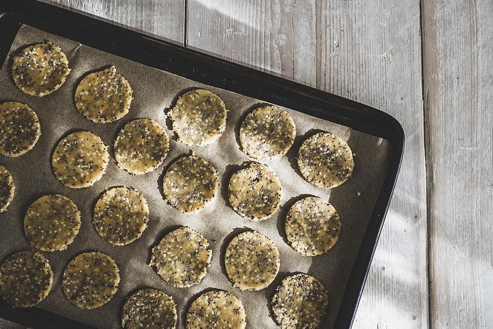 High angle close up of seeded cracker dough on a baking tray, England