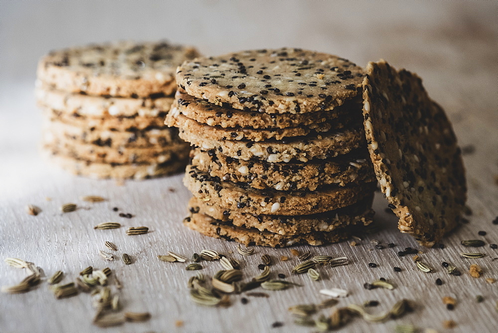 High angle close up of stack of freshly baked seeded crackers, England