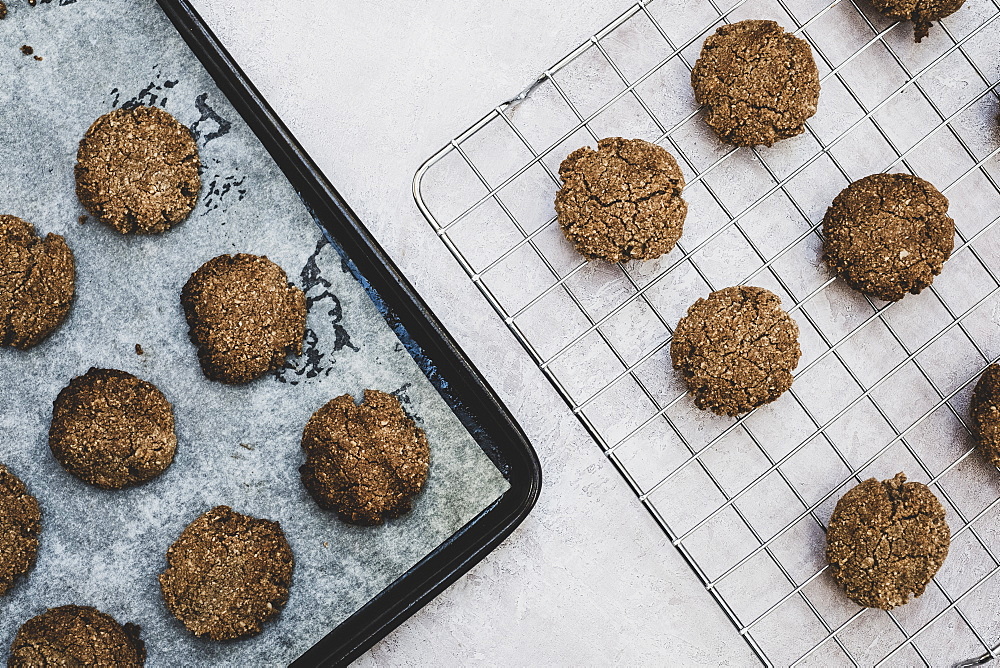 High angle close up of freshly baked chocolate cookies on a baking tray, England