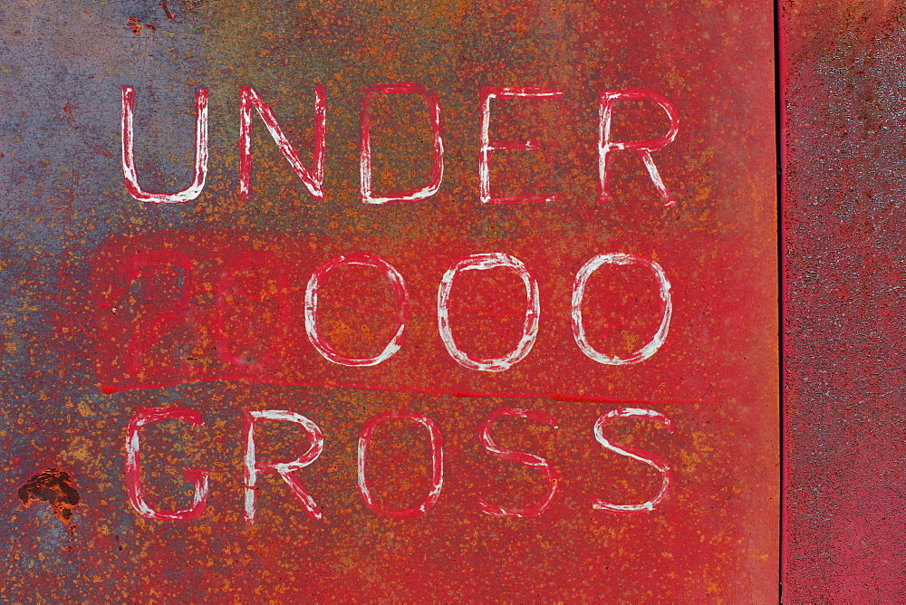 "Under 000 Gross" painted on side of old truck door, Whitman County, Washington, USA