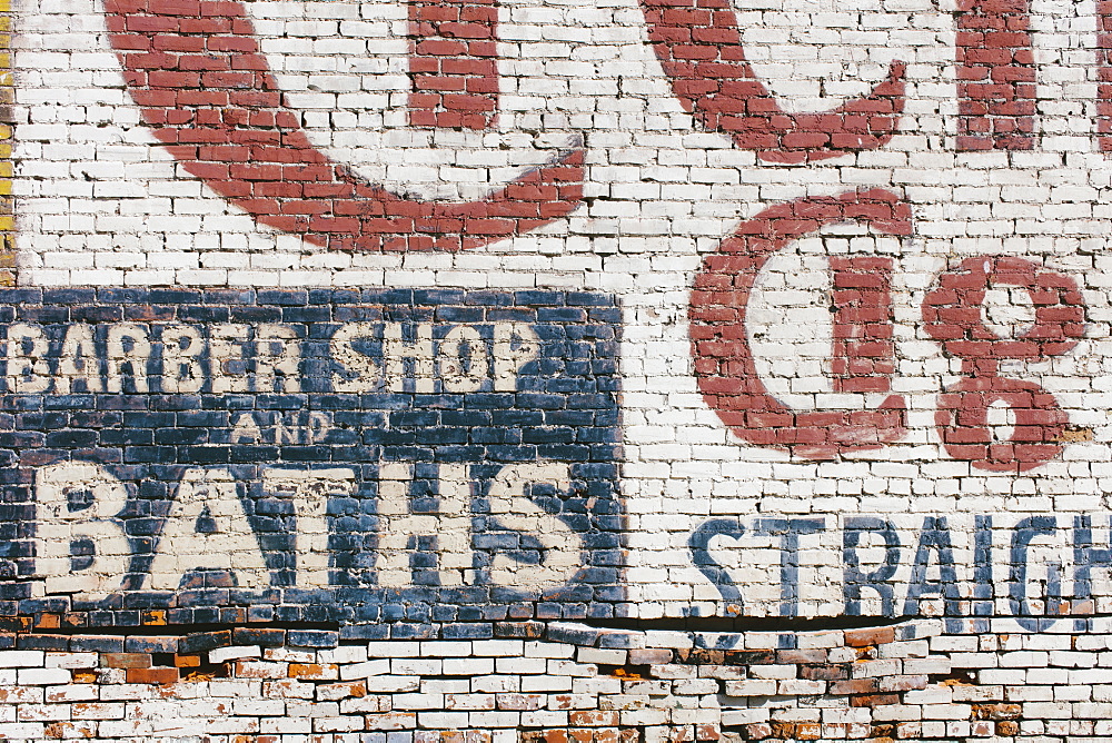 "Barber Shop & Baths" sign painted on old brick wall, Palouse County, Washington, USA