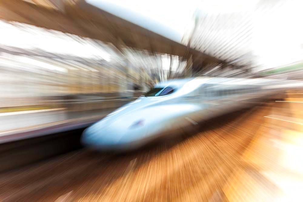 Blurred motion view of Shinkansen Bullet Train at the platform of Tokyo Station, Japan